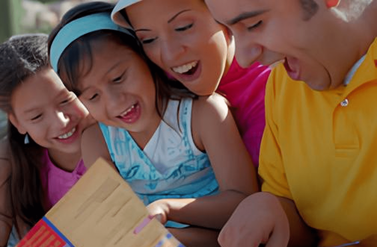 Parents and children laughing over book
