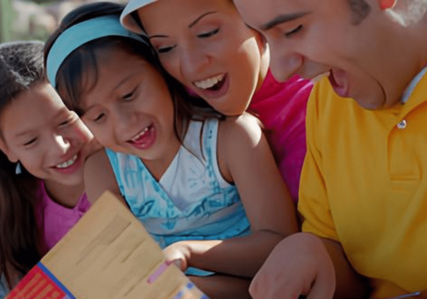 Parents and children laughing over book